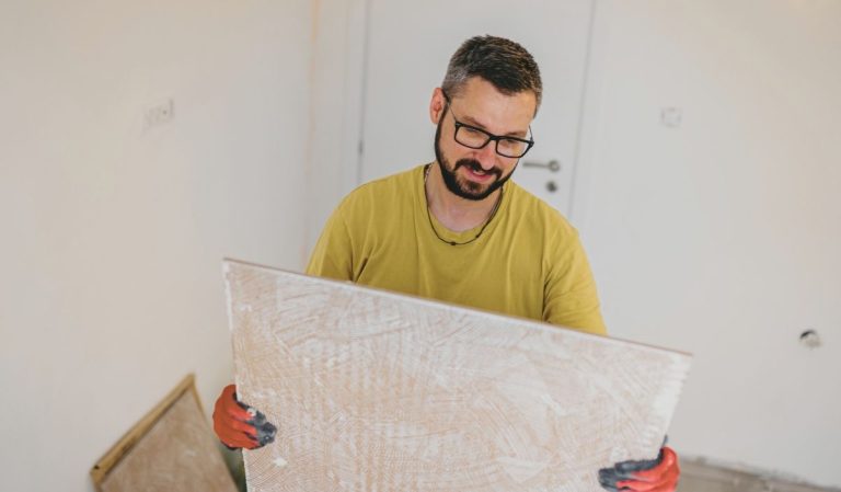 Carreleur avec un grand carreau dans ses mains
